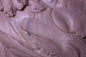 Close-up of purple cream or frosting with a smooth texture
